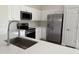Bright kitchen featuring quartz countertops, stainless steel appliances, and white cabinetry at 12586 W Amelia Ave, Avondale, AZ 85392