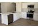 Bright kitchen featuring quartz countertops, stainless steel appliances, and new wood flooring at 12586 W Amelia Ave, Avondale, AZ 85392