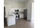 This kitchen features quartz countertops, stainless steel appliances, and new wood flooring at 12586 W Amelia Ave, Avondale, AZ 85392
