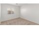 Bright carpeted bedroom with neutral walls and natural light from a window at 1371 W Gary Dr, Chandler, AZ 85224
