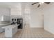 Open kitchen featuring white cabinets, tile floors, a convenient island, and black appliances at 1371 W Gary Dr, Chandler, AZ 85224