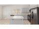 Well-lit kitchen featuring an island, ample cabinet space, and black appliances at 1371 W Gary Dr, Chandler, AZ 85224