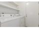 Bright laundry area with door and overhead shelves at 1371 W Gary Dr, Chandler, AZ 85224