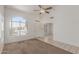 Bright living room with vaulted ceilings, a large arched window, and neutral-colored carpet and tile flooring at 1371 W Gary Dr, Chandler, AZ 85224