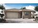 Charming single-story home featuring stone accents, a covered porch, and an attached two-car garage at 14850 N 56Th Dr, Glendale, AZ 85306