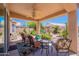 Inviting back patio featuring comfortable seating, exterior fan, and clear views of desert landscape at 17293 N Ponca Way, Surprise, AZ 85374