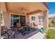 Inviting back patio featuring comfortable seating, exterior fan, and clear views of desert landscape at 17293 N Ponca Way, Surprise, AZ 85374