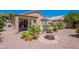Beautiful backyard featuring a charming fountain and covered patio with desert landscaping at 17293 N Ponca Way, Surprise, AZ 85374