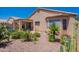 Backyard featuring gravel landscaping, cacti and yucca plants, and covered patio with furniture set at 17293 N Ponca Way, Surprise, AZ 85374