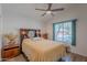 Comfortable bedroom with wood flooring featuring a bed, adjacent nightstands, and exterior view through the window at 17293 N Ponca Way, Surprise, AZ 85374