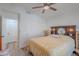 Bright bedroom with a ceiling fan, closet and stylish bedding, creating a cozy retreat at 17293 N Ponca Way, Surprise, AZ 85374