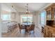Cozy dining area with wood floors, stylish furniture, chandelier lighting, and a view of the backyard at 17293 N Ponca Way, Surprise, AZ 85374