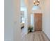 Bright entryway featuring a wooden front door, high ceilings, decorative lighting, and views into the living area at 17293 N Ponca Way, Surprise, AZ 85374