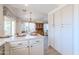 White kitchen featuring ample counter space, stainless steel appliances, and adjacent dining area at 17293 N Ponca Way, Surprise, AZ 85374