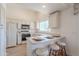 Clean kitchen with white cabinets, countertops, and stainless steel appliances, breakfast bar area at 17293 N Ponca Way, Surprise, AZ 85374