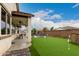 Outdoor space with a putting green, pool, seating, and covered patio, perfect for entertaining at 17909 W Agave Rd, Goodyear, AZ 85338