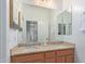 Bathroom boasts double sinks with granite countertop and a large mirror reflecting the home interior at 17909 W Agave Rd, Goodyear, AZ 85338