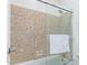 A beautifully tiled tub and shower enclosure with glass doors and a convenient towel bar at 17909 W Agave Rd, Goodyear, AZ 85338