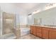 Spa-like bathroom with a tub, shower, and double vanity sinks at 17909 W Agave Rd, Goodyear, AZ 85338