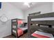 This bedroom has cozy bunkbeds with matching blankets and is equipped with a ceiling fan at 17909 W Agave Rd, Goodyear, AZ 85338