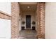 Welcoming front entry with brick columns and decorative plants at 17909 W Agave Rd, Goodyear, AZ 85338