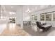 Spacious game room features sleek floors, recessed lighting, and windows with views at 17909 W Agave Rd, Goodyear, AZ 85338