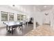 Bright and airy game room with a ping pong table, foosball table, and plenty of space for entertaining at 17909 W Agave Rd, Goodyear, AZ 85338