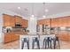Well-equipped kitchen featuring stainless steel appliances, granite countertops, and a breakfast bar with seating at 17909 W Agave Rd, Goodyear, AZ 85338