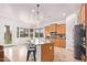 Bright eat-in kitchen features an island with seating and stainless steel appliances at 17909 W Agave Rd, Goodyear, AZ 85338