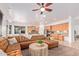 Open floorplan living room with large sectional sofa and views into the kitchen at 17909 W Agave Rd, Goodyear, AZ 85338