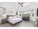 Relaxing main bedroom featuring natural light, a ceiling fan, and neutral decor at 17909 W Agave Rd, Goodyear, AZ 85338