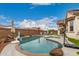 Backyard pool with basketball hoops, rock features, and lounge chairs, perfect for relaxation at 17909 W Agave Rd, Goodyear, AZ 85338
