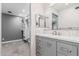 Bathroom vanity with double mirrors in bathroom with carpeted floor and walk-in closet at 18 E Hermosa Dr # 18, Tempe, AZ 85282