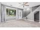 Cozy living room featuring new carpet, ceiling fan, staircase, and a large window with decorative curtains at 18 E Hermosa Dr # 18, Tempe, AZ 85282