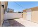 Back patio with brick pavers, white brick walls, and an outdoor shed for extra storage at 18 E Hermosa Dr # 18, Tempe, AZ 85282