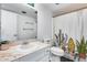 Full bathroom includes white vanity, matching toilet, and shower with patterned curtain at 1822 W Marlette Ave, Phoenix, AZ 85015