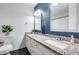 Bathroom featuring double sinks with granite countertops, mirrors and a modern lighting fixture at 1822 W Marlette Ave, Phoenix, AZ 85015