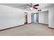 Spacious bedroom features neutral carpet, ceiling fan, and ensuite bathroom access at 1822 W Marlette Ave, Phoenix, AZ 85015