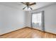Bright bedroom with wood laminate flooring, ceiling fan, and a window with sheer curtains at 1822 W Marlette Ave, Phoenix, AZ 85015