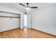 Bedroom featuring wood floors, a ceiling fan, and closet with door to the hallway at 1822 W Marlette Ave, Phoenix, AZ 85015