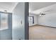 View from hall to bedroom with ceiling fan, window and neutral carpeting at 1822 W Marlette Ave, Phoenix, AZ 85015