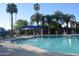 Inviting community pool featuring lounge chairs and shade umbrellas surrounded by palm trees at 1822 W Marlette Ave, Phoenix, AZ 85015
