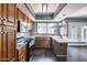 Kitchen featuring wood cabinets, granite countertops, stainless steel appliances, and view to the backyard at 1822 W Marlette Ave, Phoenix, AZ 85015