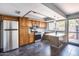 Kitchen featuring wood cabinets, granite countertops, stainless steel appliances, and view to the backyard at 1822 W Marlette Ave, Phoenix, AZ 85015