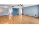 Bright living room with hardwood floors, fan, and a stairway leading to the upper level at 1822 W Marlette Ave, Phoenix, AZ 85015