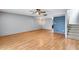Bright living room with hardwood floors, fan, and a stairway leading to the upper level at 1822 W Marlette Ave, Phoenix, AZ 85015