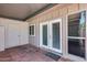 Charming covered patio with tiled flooring, doors, and a window view at 1822 W Marlette Ave, Phoenix, AZ 85015