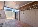 Covered patio area features tiled flooring, privacy walls, and lattice accents at 1822 W Marlette Ave, Phoenix, AZ 85015