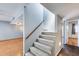 Carpeted staircase with light walls leads to the upper level with lots of natural light at 1822 W Marlette Ave, Phoenix, AZ 85015