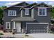 Charming two-story home with a gray exterior, covered entry, and a two-car garage at 1932 E Night Rider Rd, San Tan Valley, AZ 85140